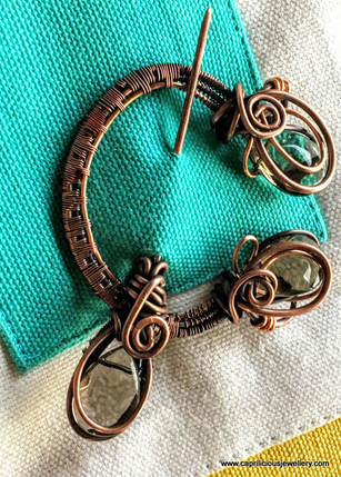Copper wire penannular brooch by Caprilicious Jewellery