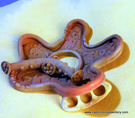 The final stages in the making of a bronze clay clasp by Caprilicious Jewellery