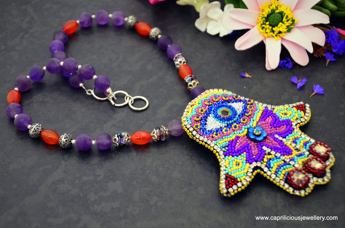 Spice Route - Tiger Iron cabochon, soutache and beadwork by Caprilicious Jewellery on a Tiger eye bead necklace