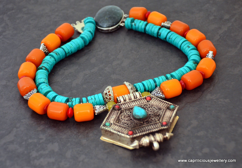 A Ghau box pendant on a necklace of faux beeswax amber and turquoise dyed magnesite by Caprilicious Jewellery