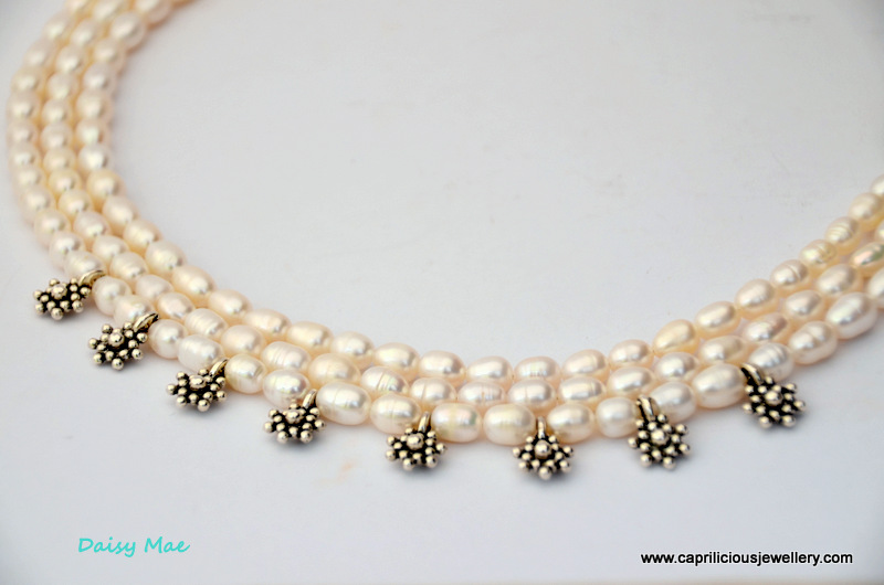 Multi strand pearl necklace with a whimsical touch and turquoise clasp by Caprilicious