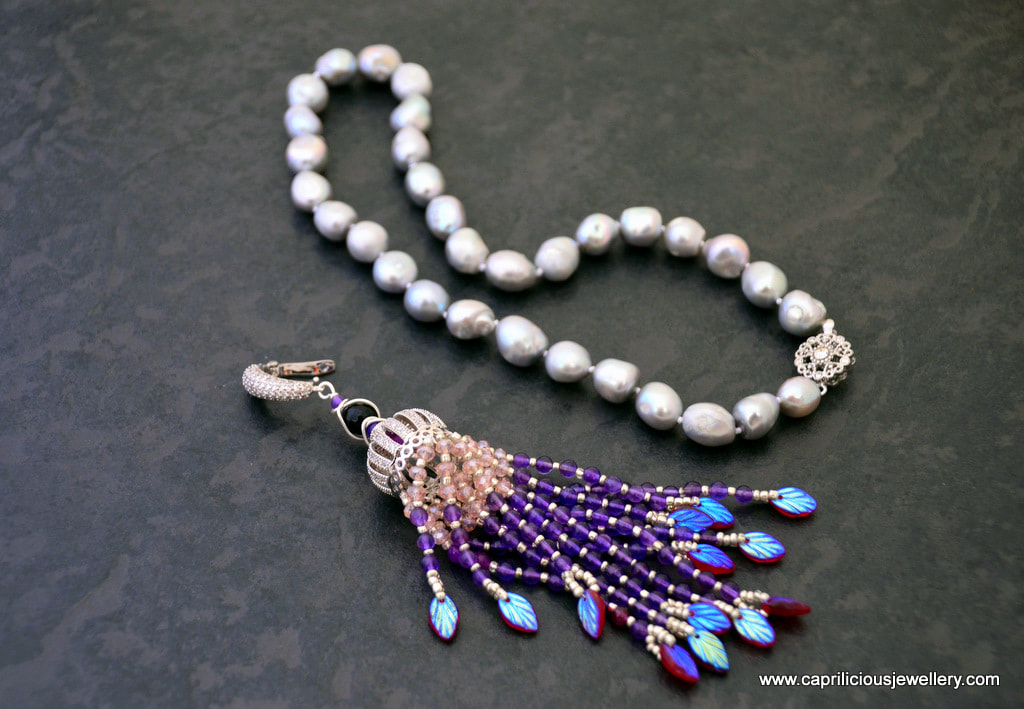Silver grey baroque pearl knotted necklace with a detachable amethyst and crystal tassel pendant by Caprilicious Jewellery