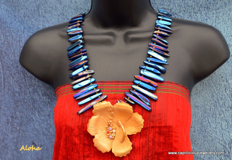Aloha - hibiscus bronze clay flower on a necklace of quartz needles, electroplated with titanium by Caprilicious Jewellery
