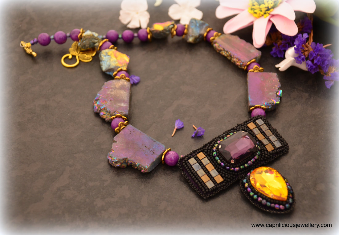 Jezebel, a statement necklace in purple crystals and titanium coated druzy by Caprilicious Jewellery
