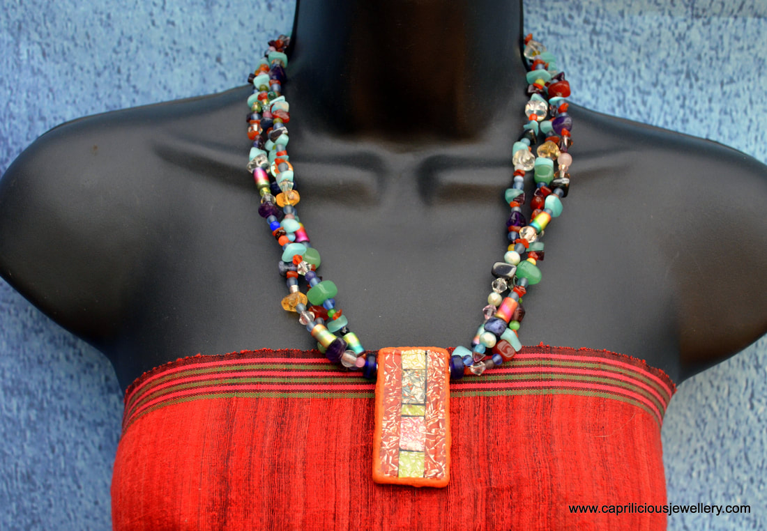 Bead Soup necklace with polymer clay and resin pendant by Caprilicious Jewellery