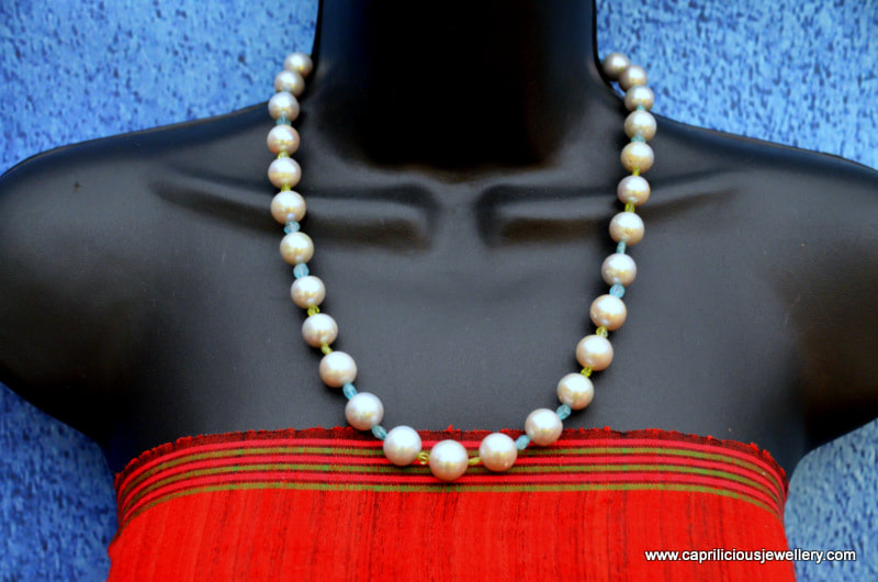 Silvery baroque pearls, with apatite and peridot in a beautiful statement necklace by Caprilicious Jewellery