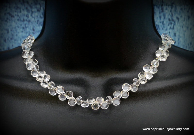 Necklace of clear quartz teardrop beads with a silver clasp, earrings to match by Caprilicious Jewellery