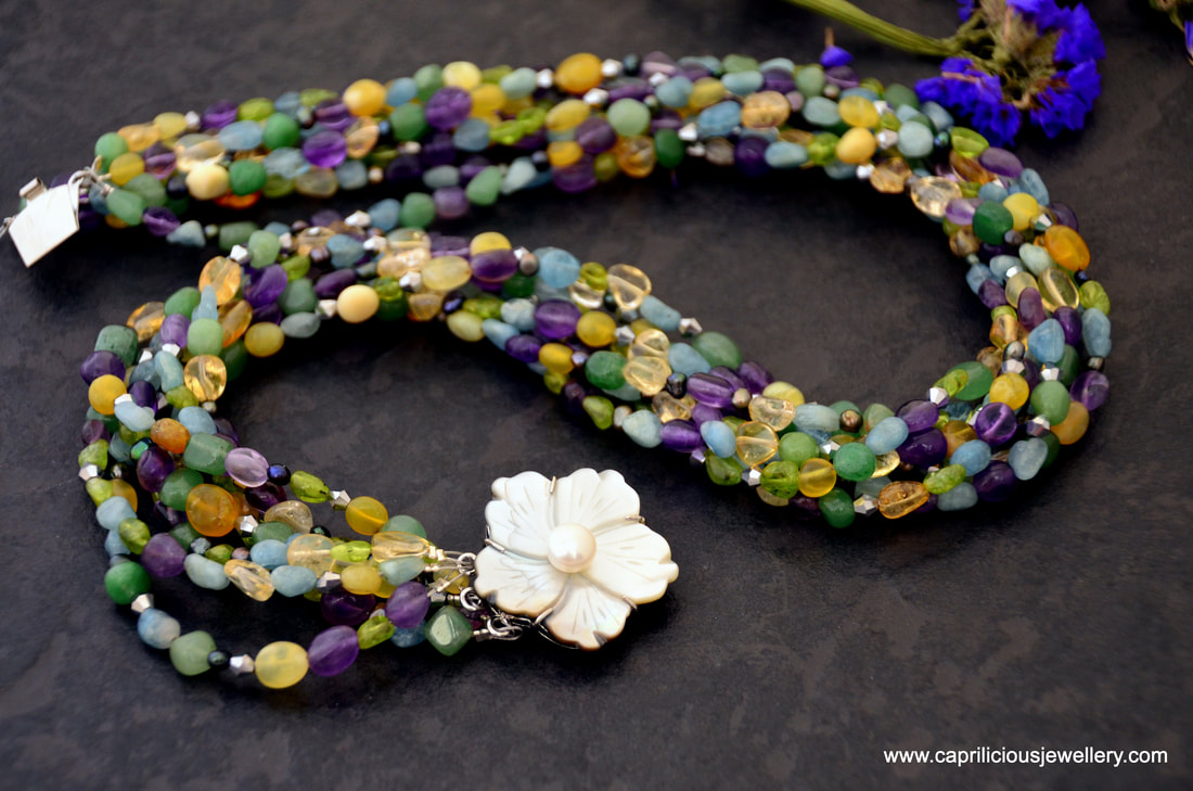 Multi strand statement necklace with aventurine, citrine, jade, aquamarine, amethyst, peridot, pearls and crystals