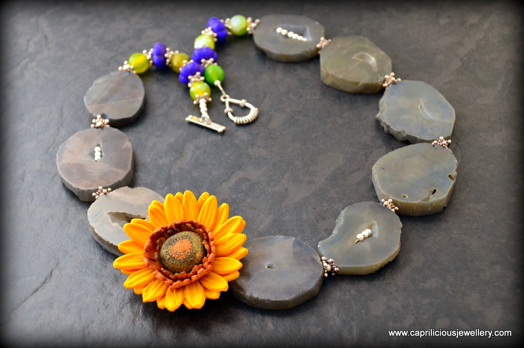 Polymer clay sunflower and slab nugget agate druzy beads in a mixed media necklace by Caprilicious Jewellery 