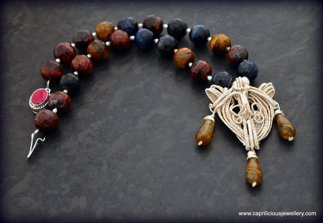 WIrework pendant on a necklace of tiger eye beads by Caprilicious Jewellery