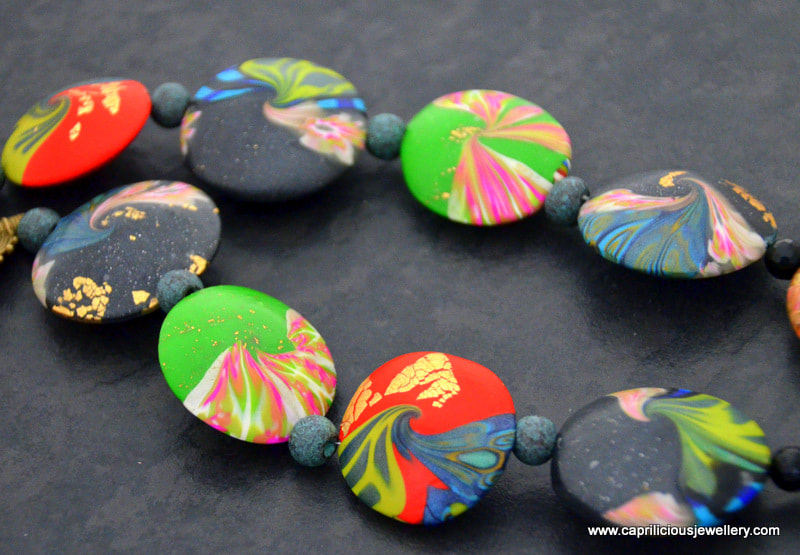 Tribal polymer clay necklace, with lentil swirl 'cosmic' beads by Caprilicious Jewellery