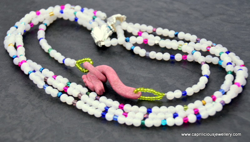 Varuna - a rhodochrosite seahorse clasp on a multistrand white matte crackle agate and crystal necklace by Caprilicious Jewellery