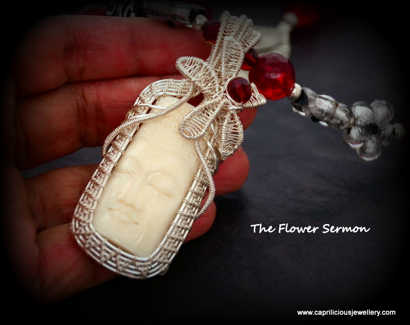 The Flower Sermon, an ox bone pendant with a Buddha set in hand made wire work by Caprilicious Jewellery in a red quartz/Krobo bead necklace