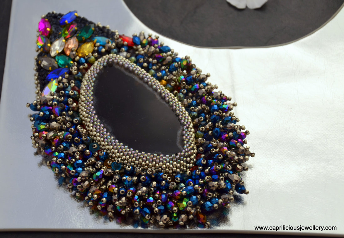 Comet, a hand beaded slab nugget on a leather necklace by Caprilicious Jewellery