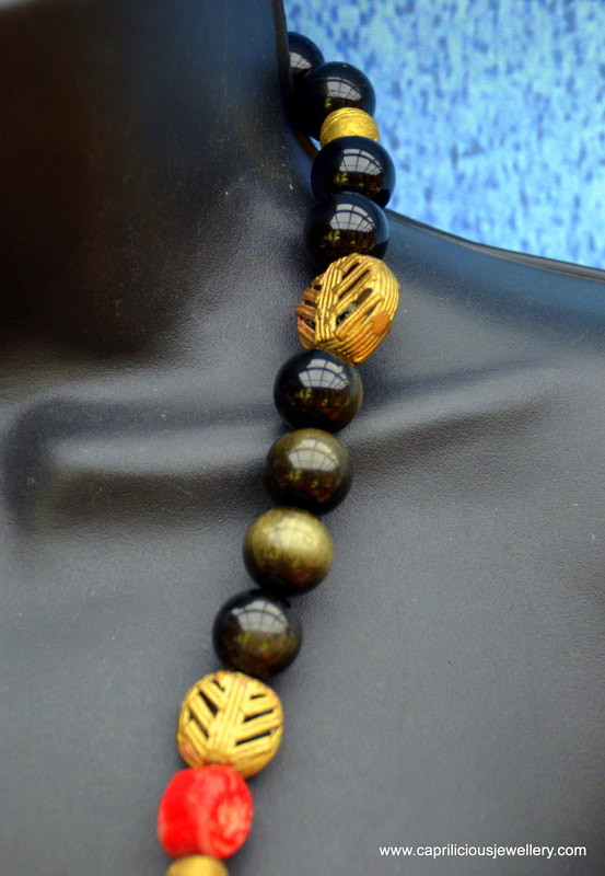 Pendant from Afghanistan, golden obsidian and coral chunks, lost wax cast beads from Kenya