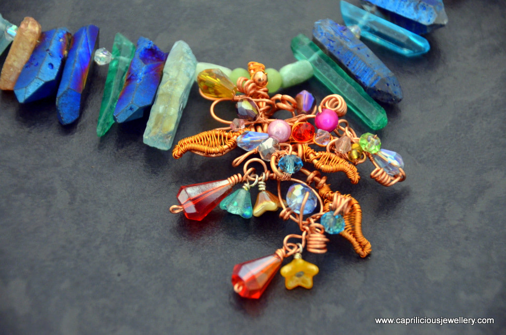 Wire work pendant with crystals and a colourful needle quartz necklace by Caprilicious Jewellery