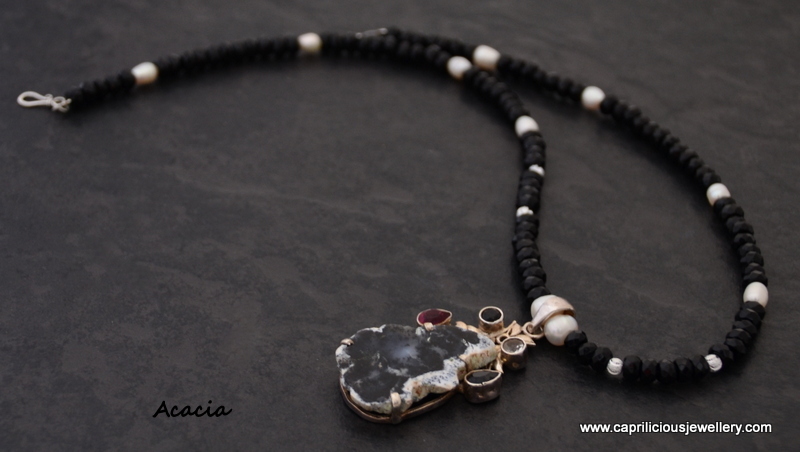 Dendritic opal pendant in sterling silver, on an onyx, pearl and silver bead necklace by Caprilicious Jewellery