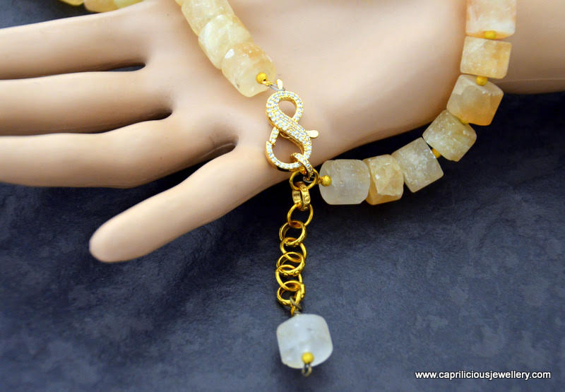 Matte citrine cylinders in a necklace with a diamante clasp by Caprilicious Jewellery