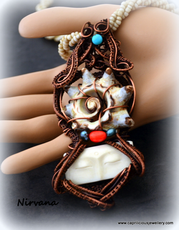 Nirvana - a hand carved bone face and slice of shell wrapped in copper wire by Caprilicious Jewellery