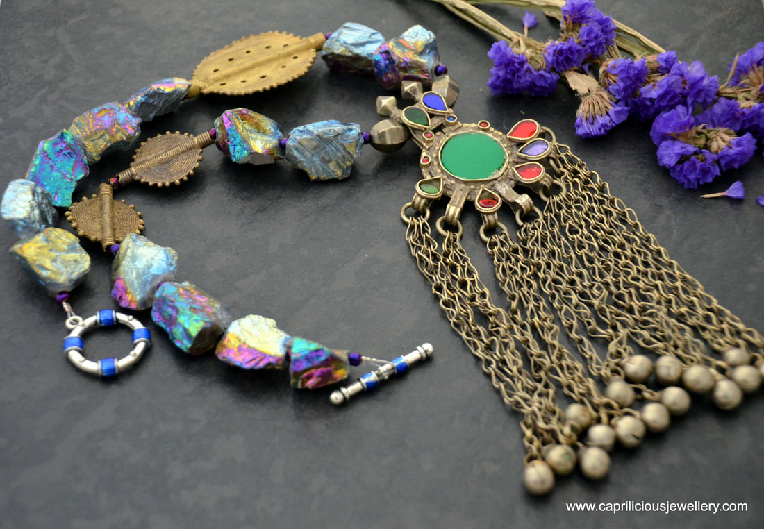 Ghazal - a necklace with titanium coated quartz nuggets, African lost wax cast beads and a pendant from Afghanistan by Caprilicious