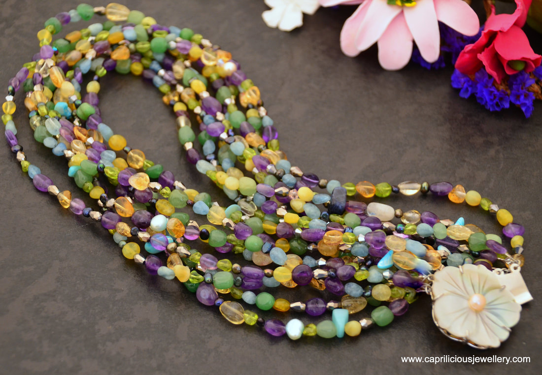 Multi strand statement necklace with aventurine, citrine, jade, aquamarine, amethyst, peridot, pearls and crystals