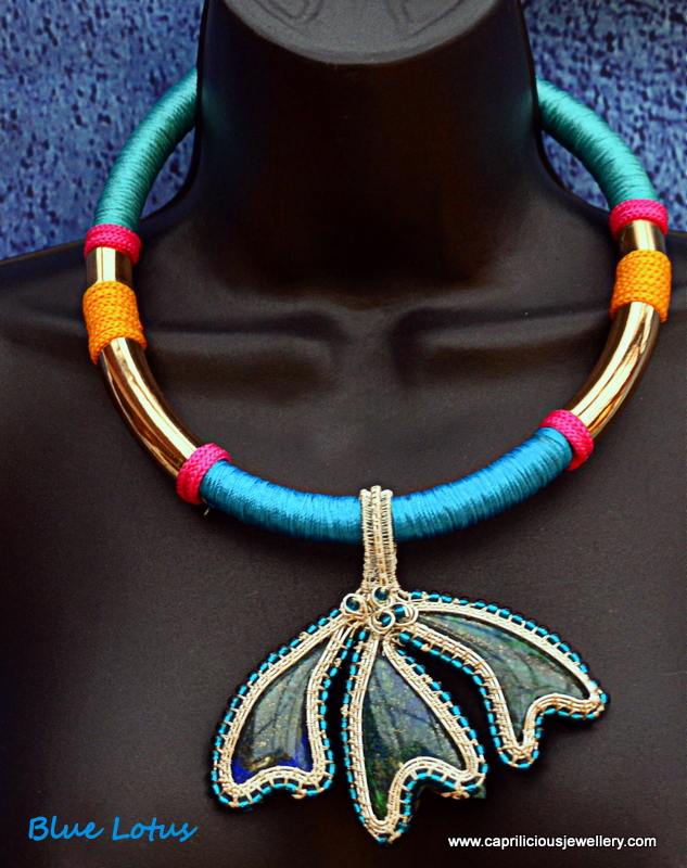 Chrysocolla multi stone pendant set in a wire work surround on a Tibetan threadwork necklace