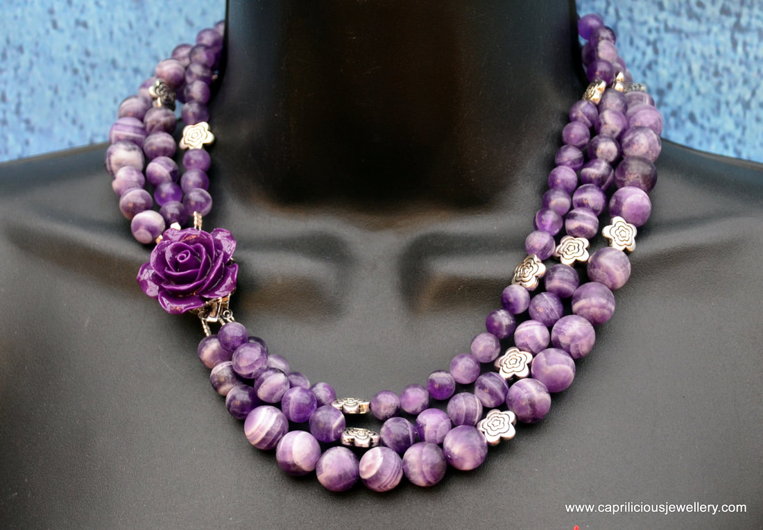 Three strand matte striate amethyst necklace with a resin rose clasp by Caprilicious Jewellery