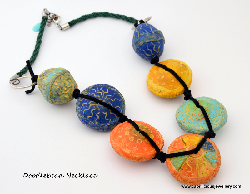 Necklace made with hollow carved polymer clay beads knotted on ultrasuede and Kumihimo by Caprilicious Jewellery