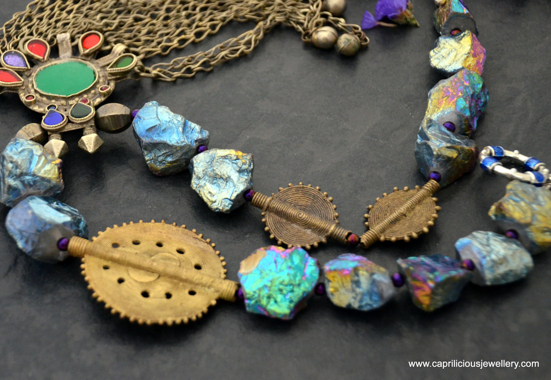 Ghazal - a necklace with titanium coated quartz nuggets, African lost wax cast beads and a pendant from Afghanistan by Caprilicious