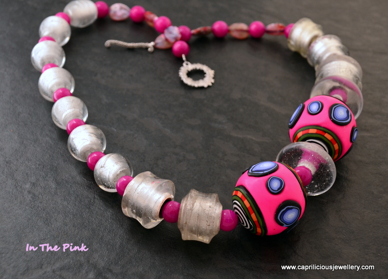 A polymer clay and silver foiled glass bead necklace by Caprilicious Jewellery