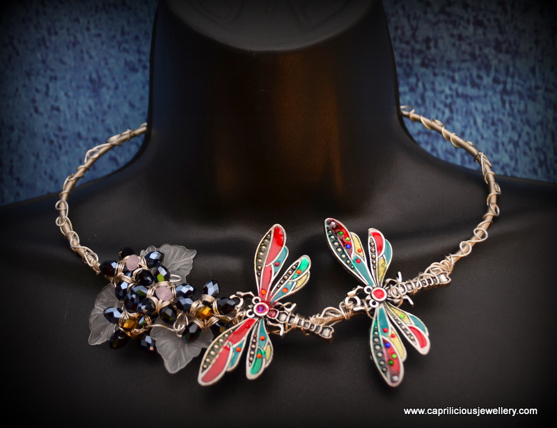 Cold enamelled dragonflies on a free form wire work torque necklace with crystal teardrop flowers and lucite leaves by Caprilicious Jewellery