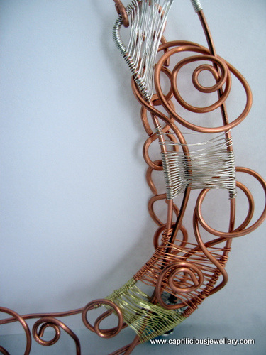 Rutilated quartz cab in an asymmetrical wire necklace by Caprilicious Jewellery