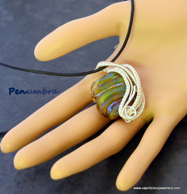 Lampwork glass bead in wire work by Caprilicious Jewellery