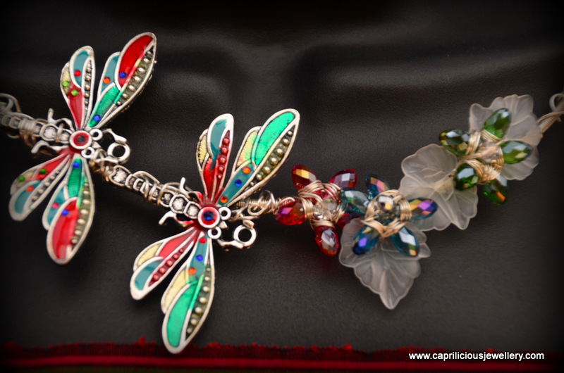 Cold enamelled dragonflies on a free form wire work torque necklace with crystal teardrop flowers and lucite leaves by Caprilicious Jewellery