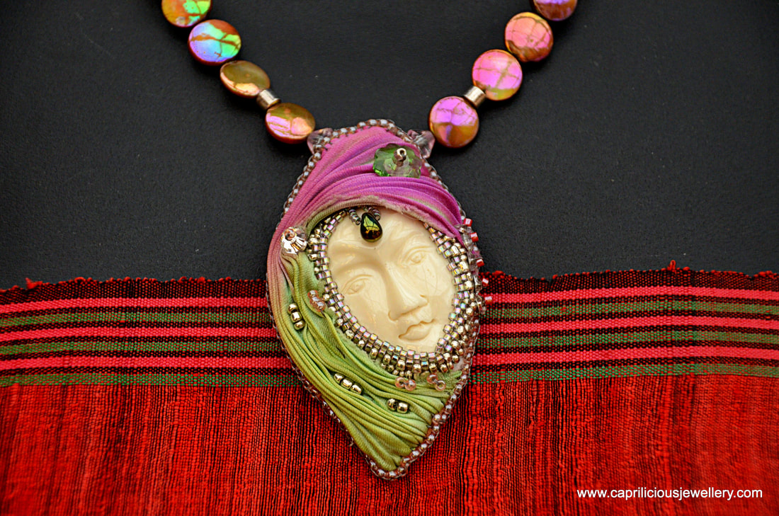 Yak bone face and Shibori ribbon and beadwork pendant by Caprilicious Jewellery