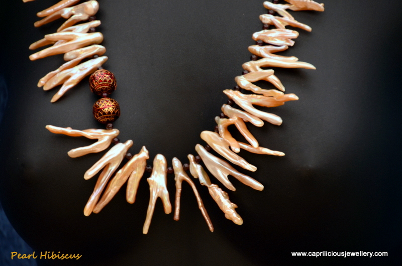 Biwa pearl and garnet necklace with a large bronze clay clasp by Caprilicious Jewellery