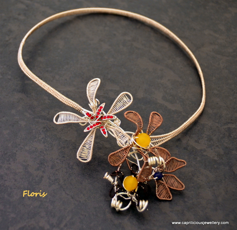 Wire woven torque necklace with hand woven flowers by Caprilicious Jewellery