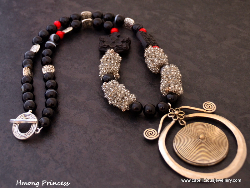 Hmong pendant on a black agate, cinnabar, crystal and hand made wire bead necklace by Caprilicious Jewellery
