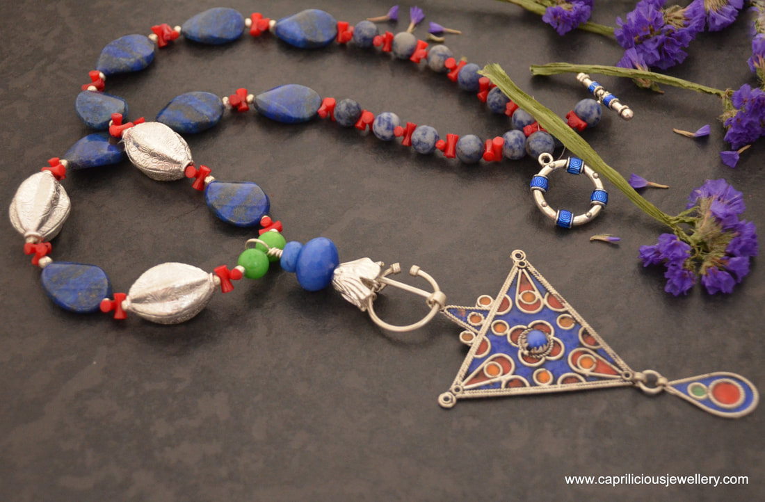 Penannular fibula necklace with an enamelled pendant from Morocco on a necklace of lapis lazuli and coral by Caprilicious Jewellery
