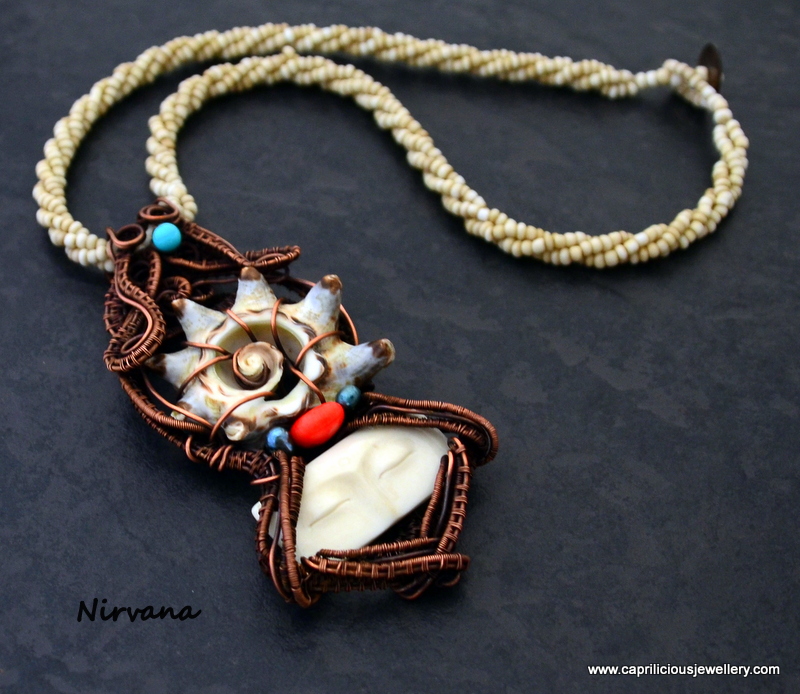 Nirvana - a hand carved bone face and slice of shell wrapped in copper wire by Caprilicious Jewellery