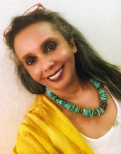 Neena Shilvock, the jewellery designer in a turquoise dyed magnesite and raw amethyst necklace by Caprilicious Jewellery